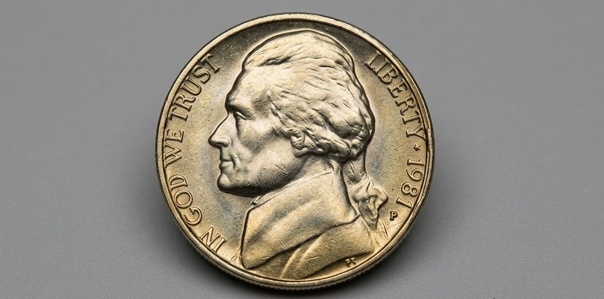 Close-up of a 1981 Jefferson nickel on a neutral gray background
